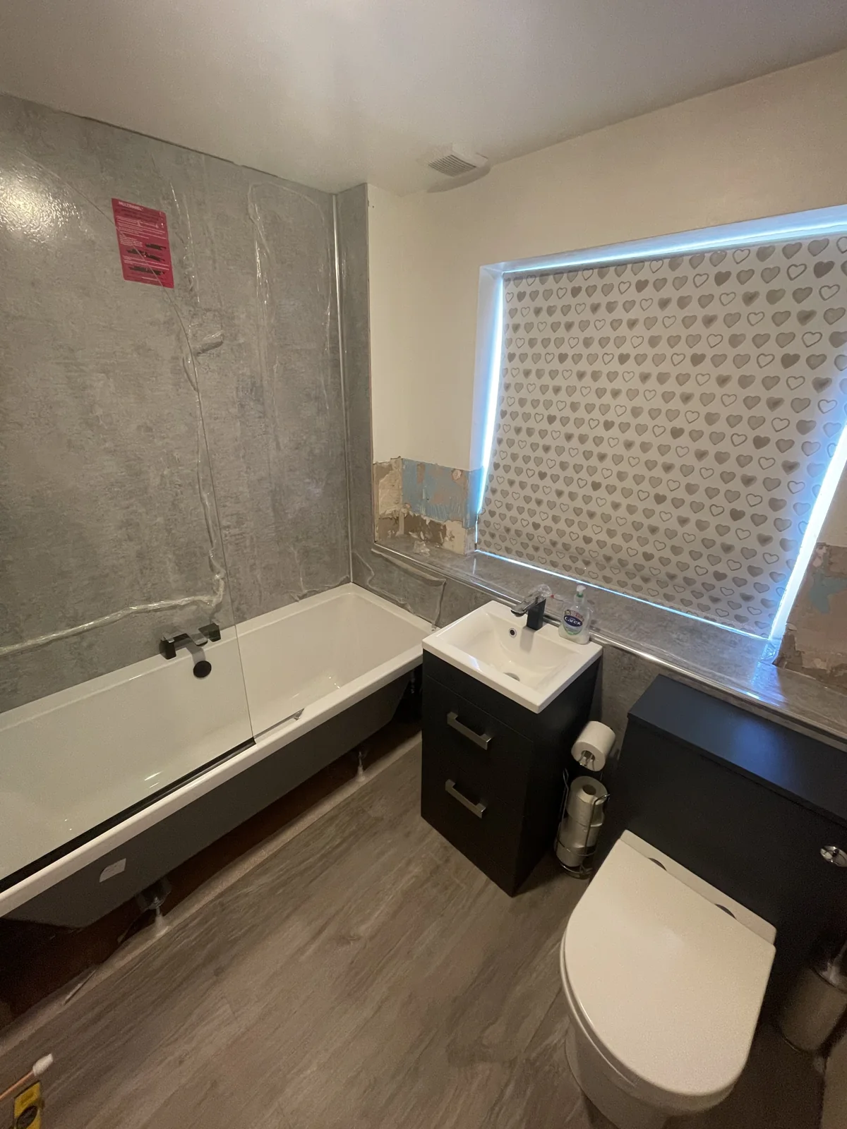 Bathroom with protective film and unfinished wall areas