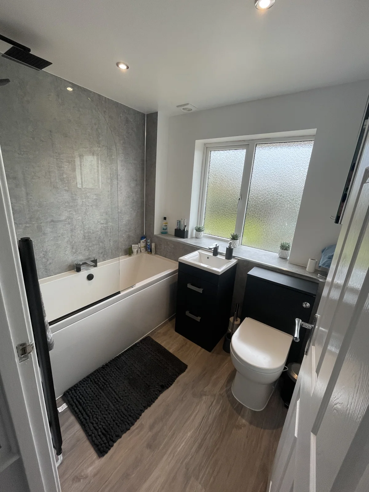 Finished bathroom with bath, vanity and toilet