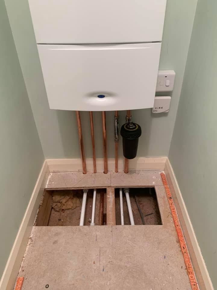 Copper boiler pipework with the floor open during installation
